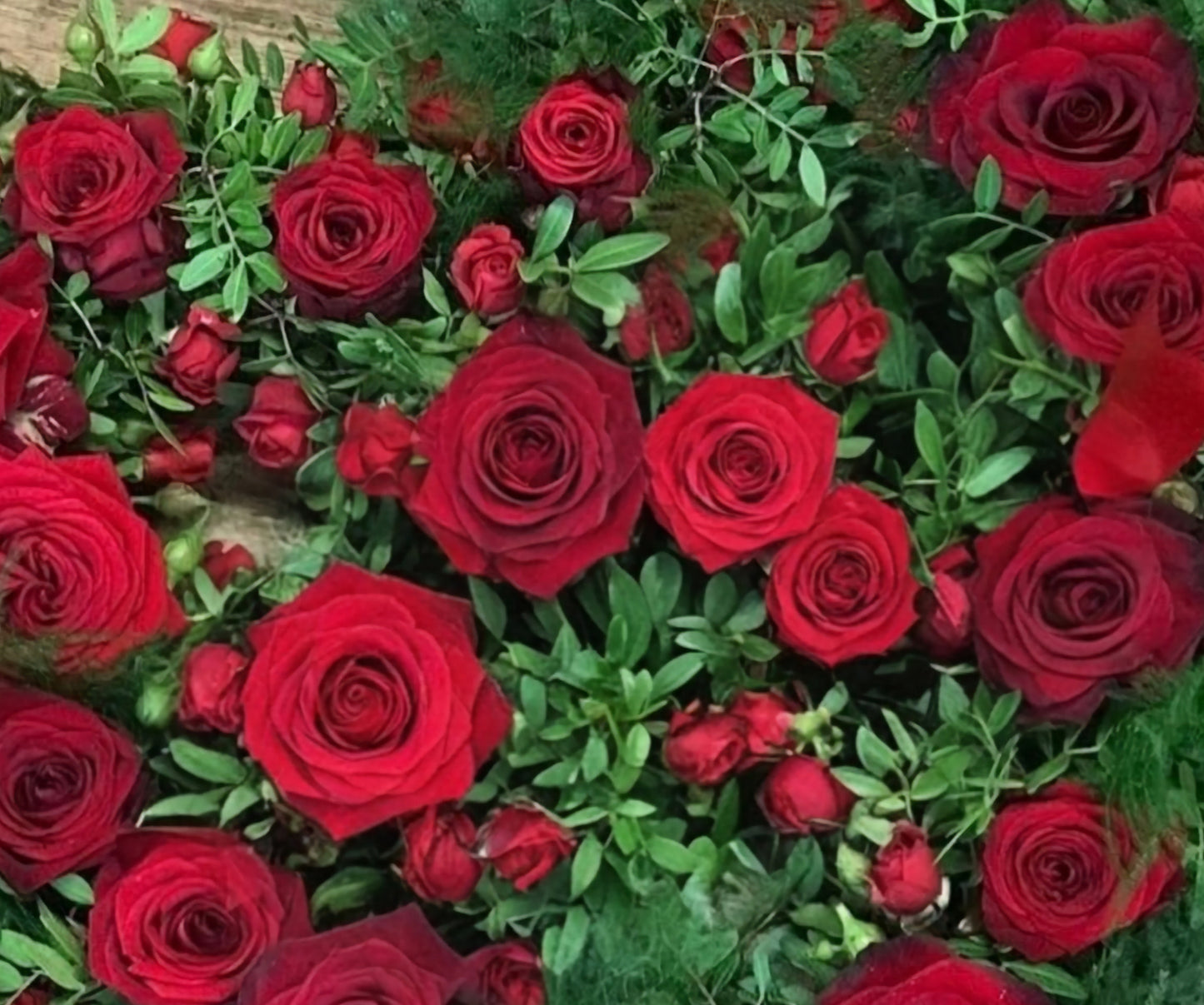 Bouquet of red roses with green leaves