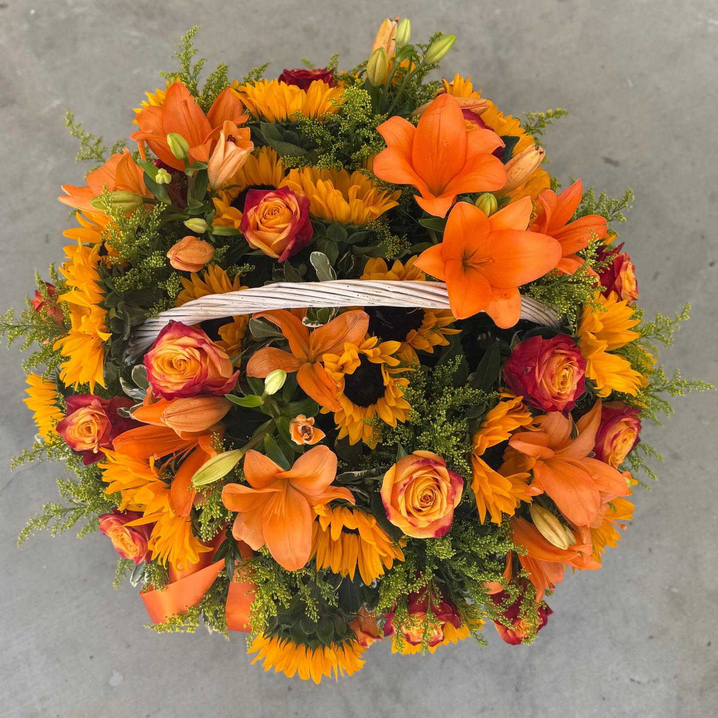 Bouquet of orange and yellow flowers on a gray surface